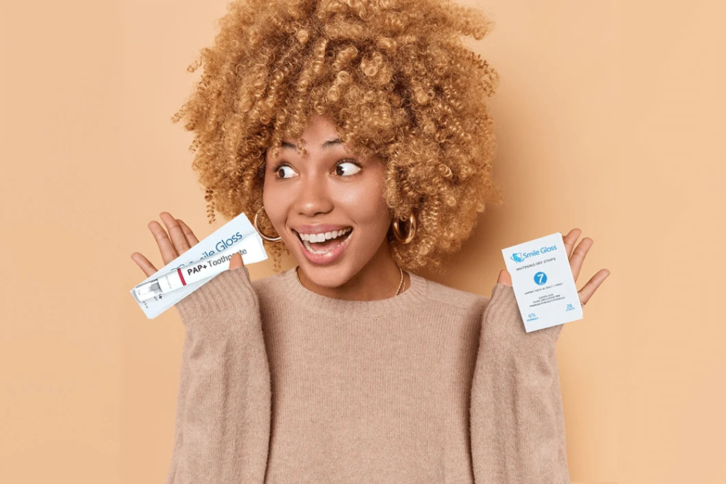 a girl holding pap toothbrush